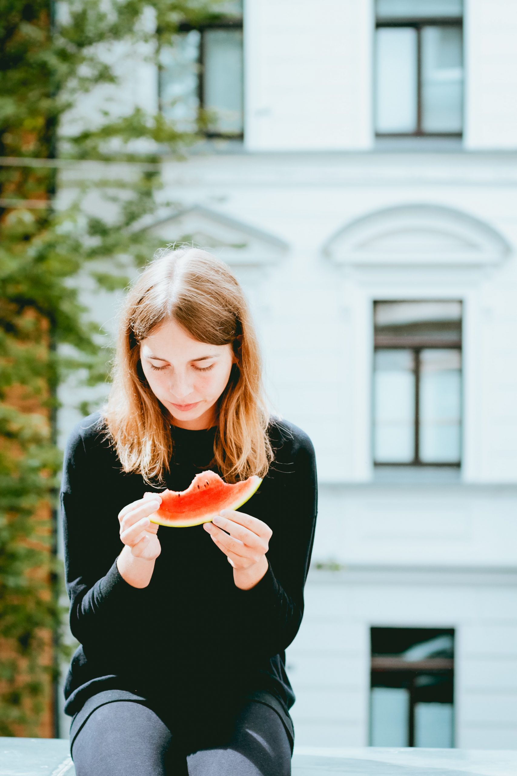 Young woman eating a watermelon.